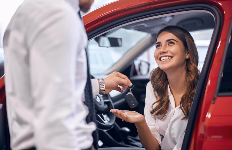 dealer-giving-keys-happy-customer_251859-2891