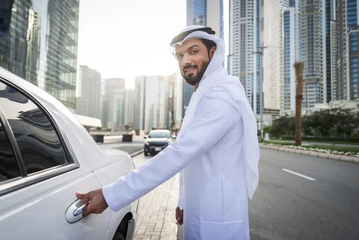 portrait-man-opening-car-road-city_1048944-6183393